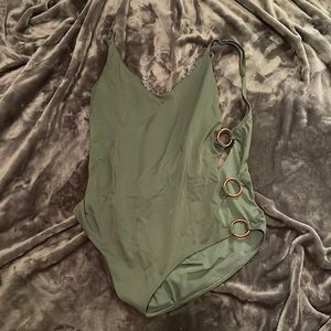 Olive green once piece swim suit with bronze rings on each side